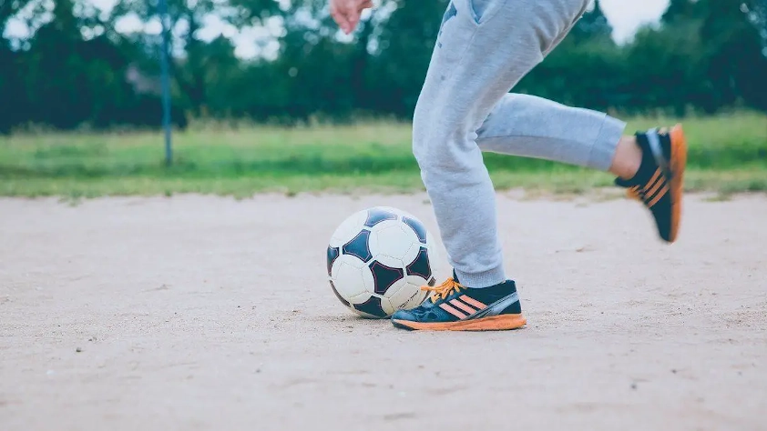 Player working on solo football drills against a wall.